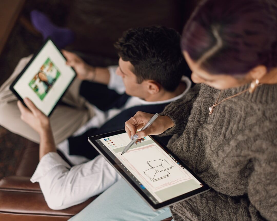 Two editors reviewing a live coverage plan on a tablet